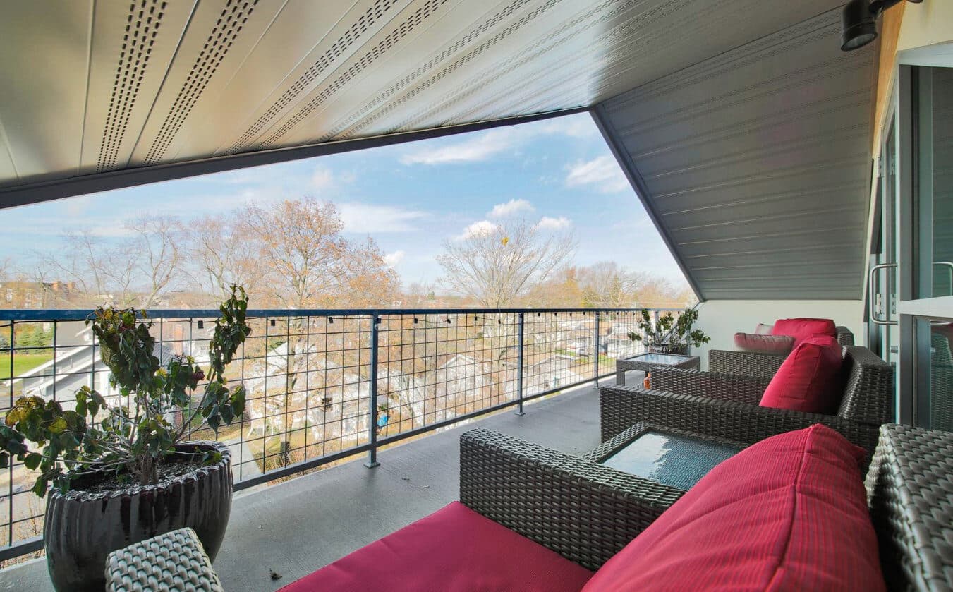 Upper-floor balcony detail with metal railing at 300 Hamilton mixed-use building