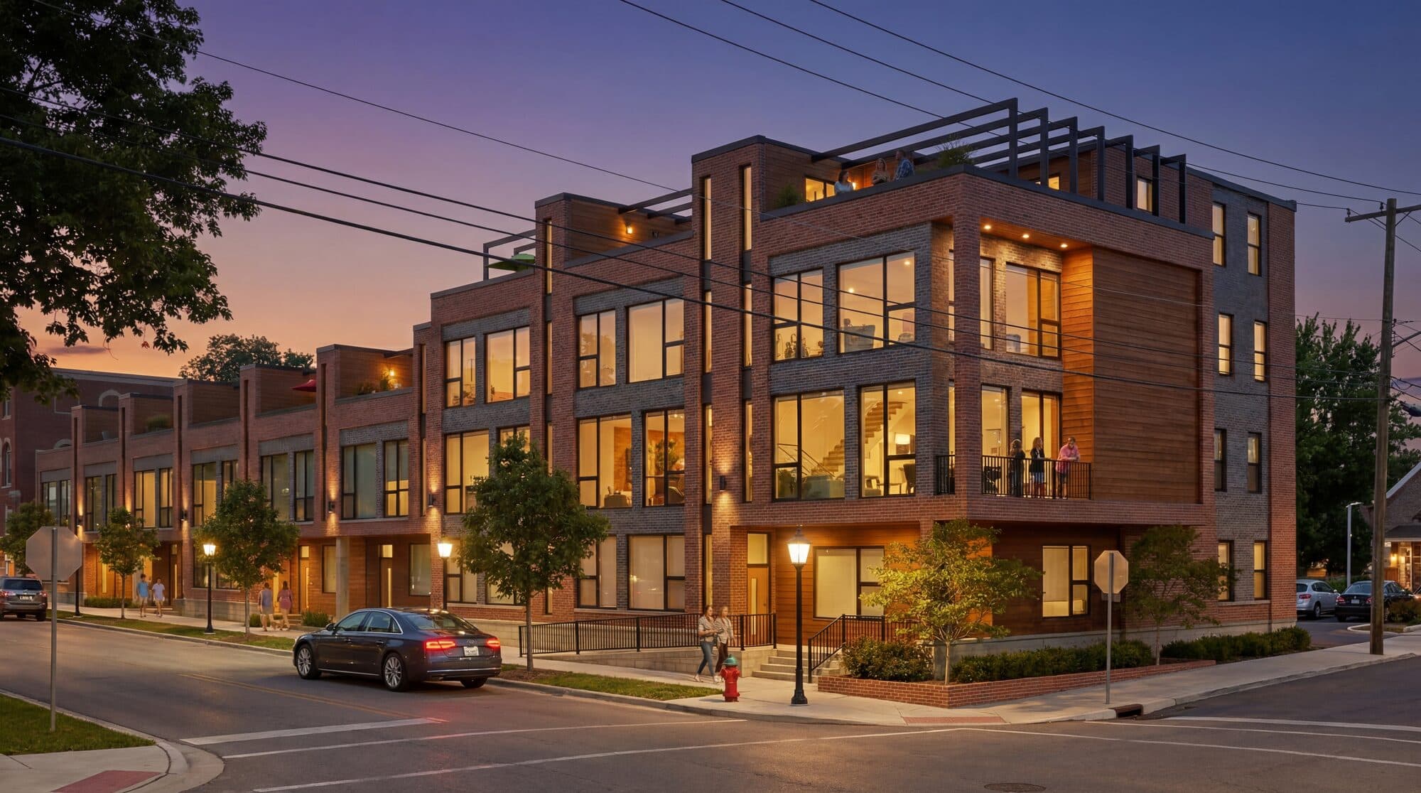 Corner House mixed-use building at night in Rochester Hills Michigan with warm lighting and commanding corner presence