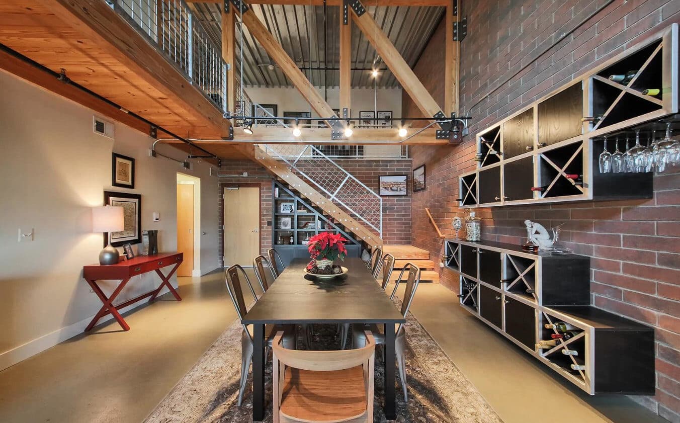 Detroit loft interior renovation with wine storage wall and warm wood dining area