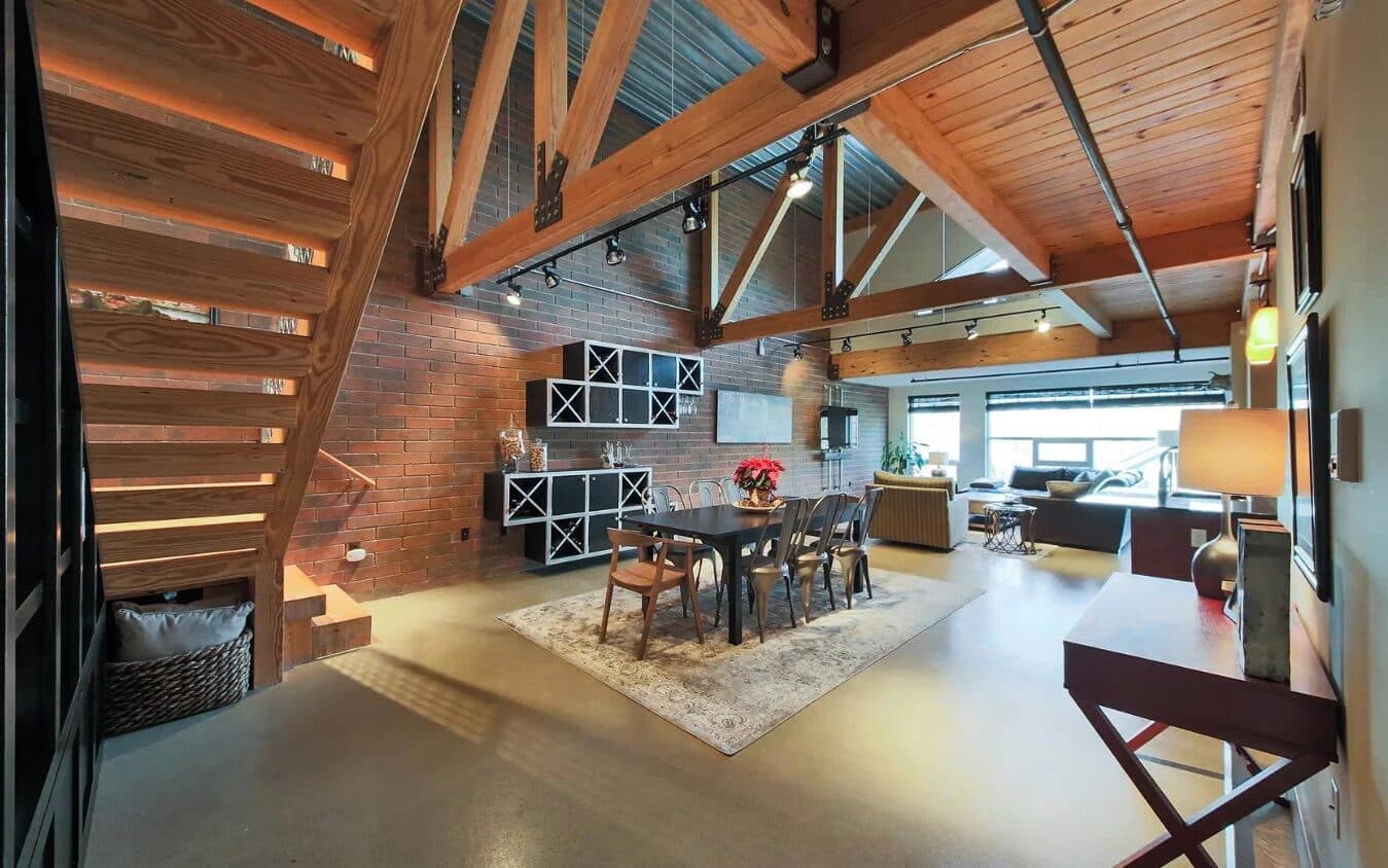 Open loft living space with layered zones defined by material changes rather than walls