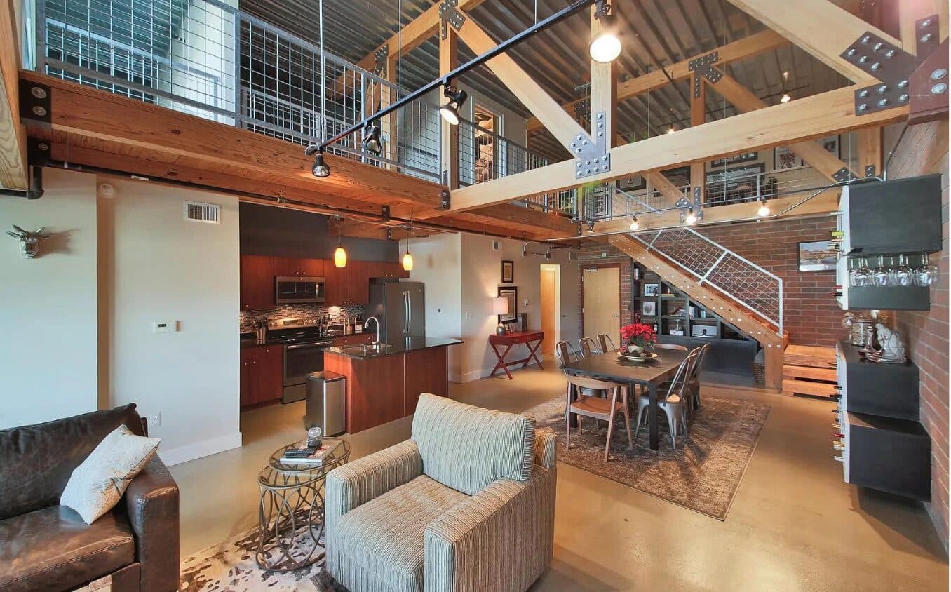 Kitchen area with blackened steel accents and warm wood cabinetry in Detroit loft