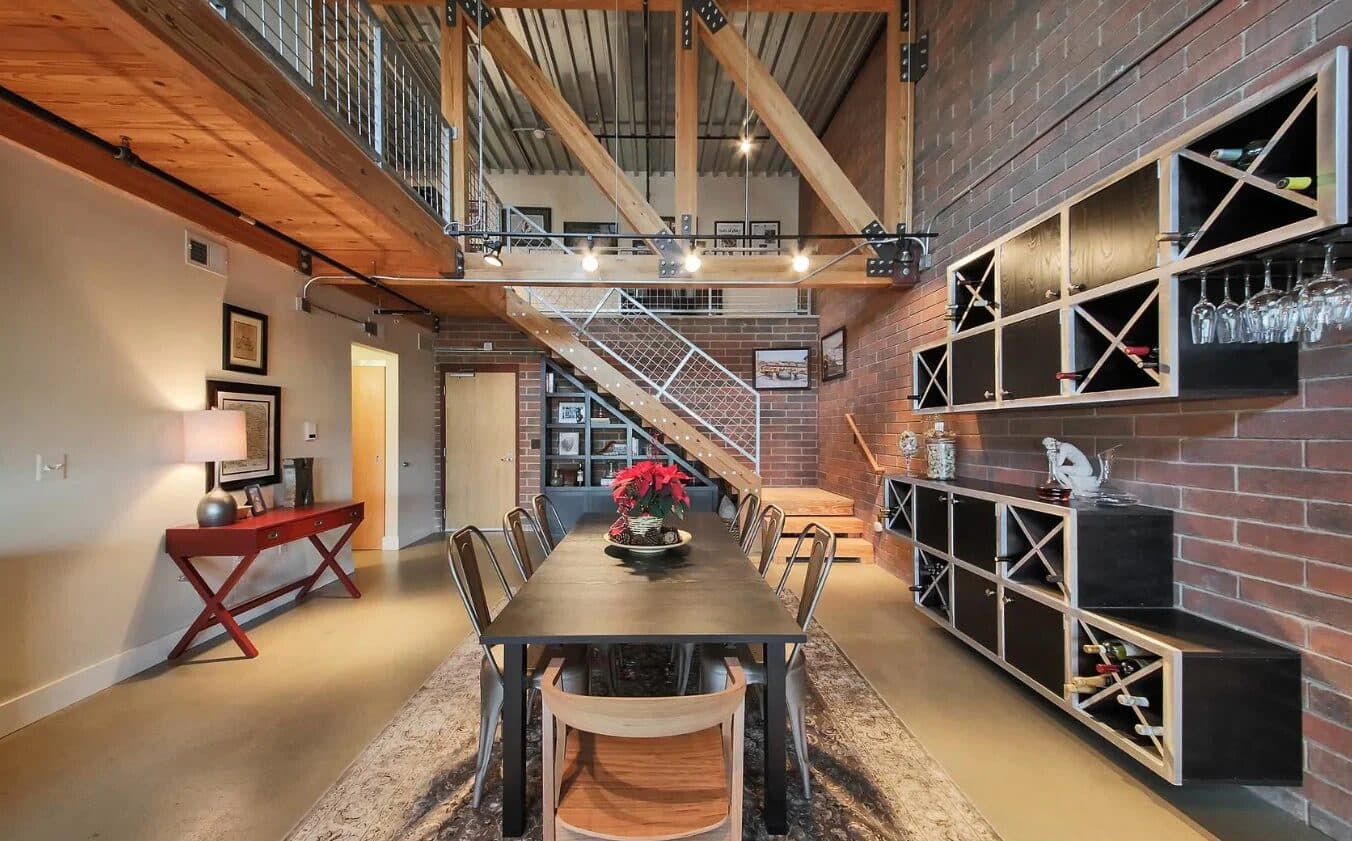 Living area showing soft textiles and warm wood giving depth to the open loft plan
