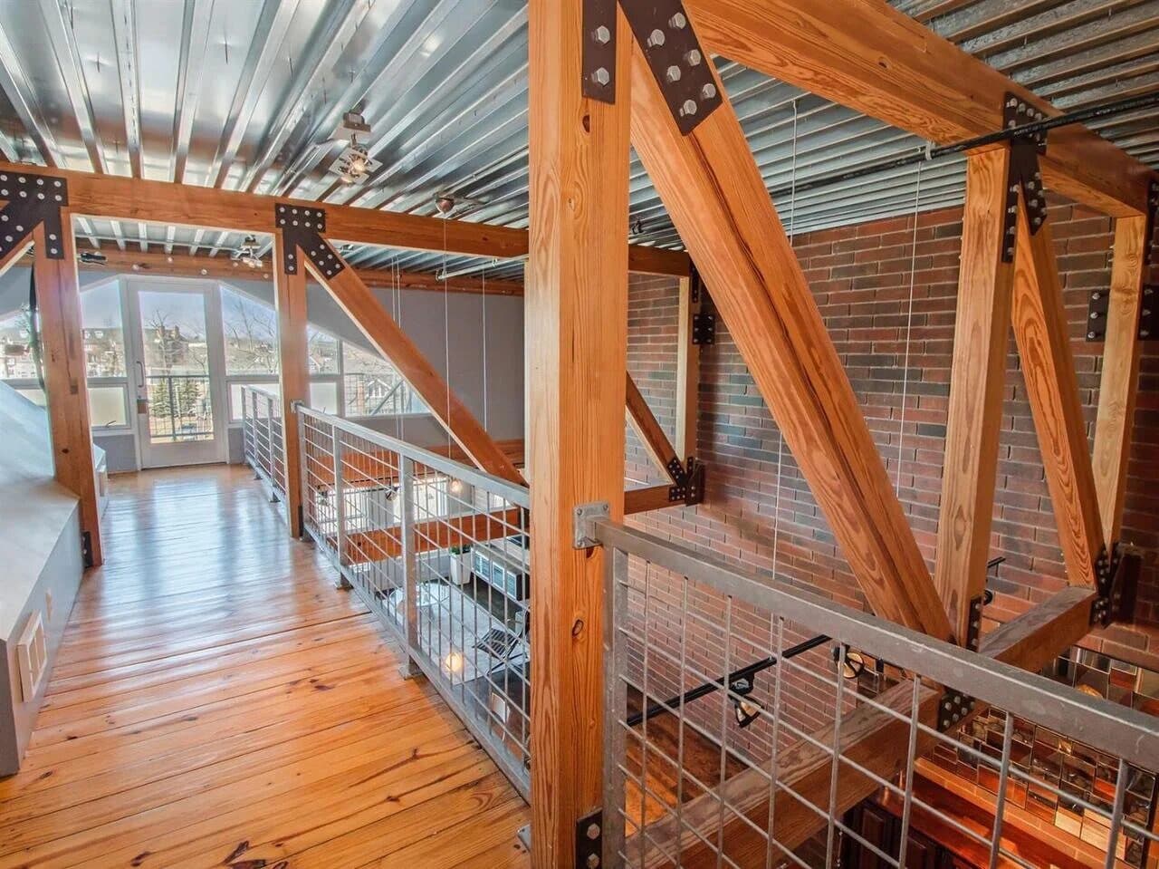 Bedroom zone within the loft interior using built-in storage as a room divider