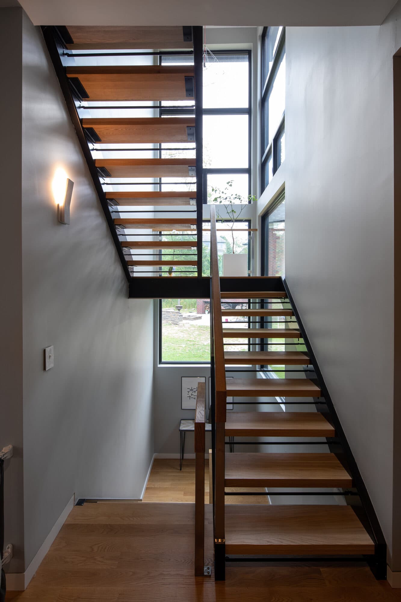 Sculptural interior staircase connecting public and private levels of the home