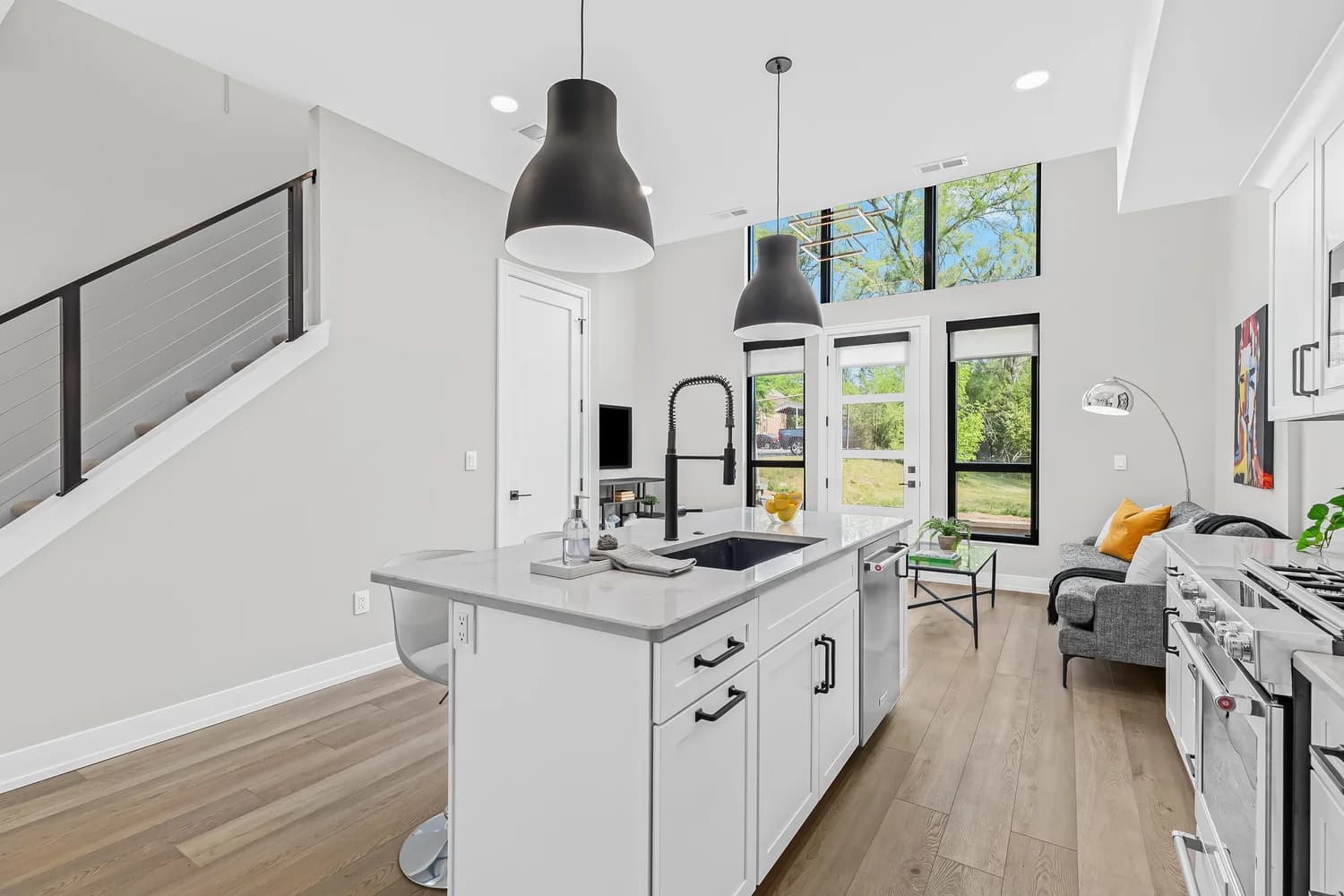 Renovated kitchen with white oak floors and modern cabinetry at Tienken Traillofts