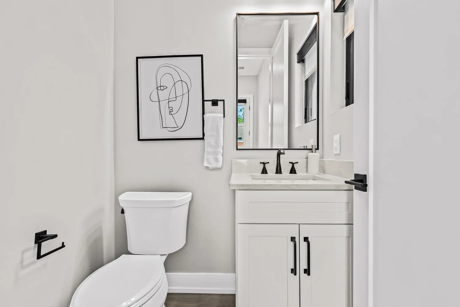 Renovated powder room with modern fixtures and warm material palette