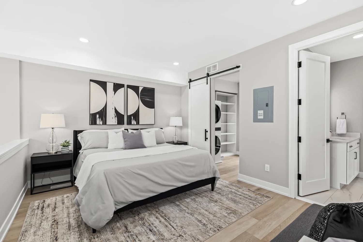 Primary bedroom with vaulted ceiling and minimalist design in Royal Oak renovation