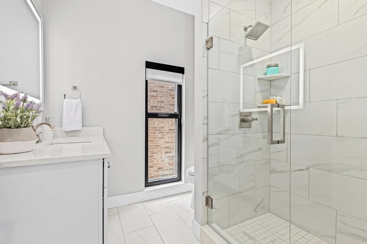 Renovated bathroom with contemporary tile and fixtures