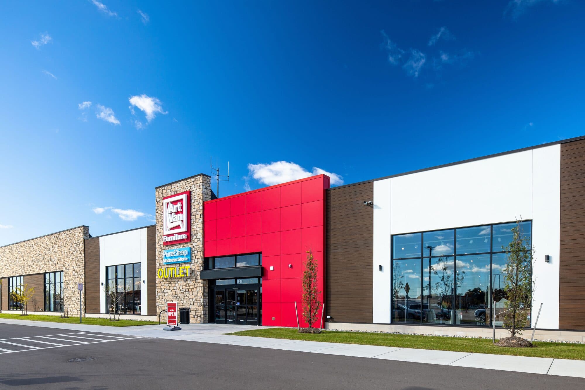 Winchester Center daytime exterior showing stone tower entry and long retail facade with distinct bays