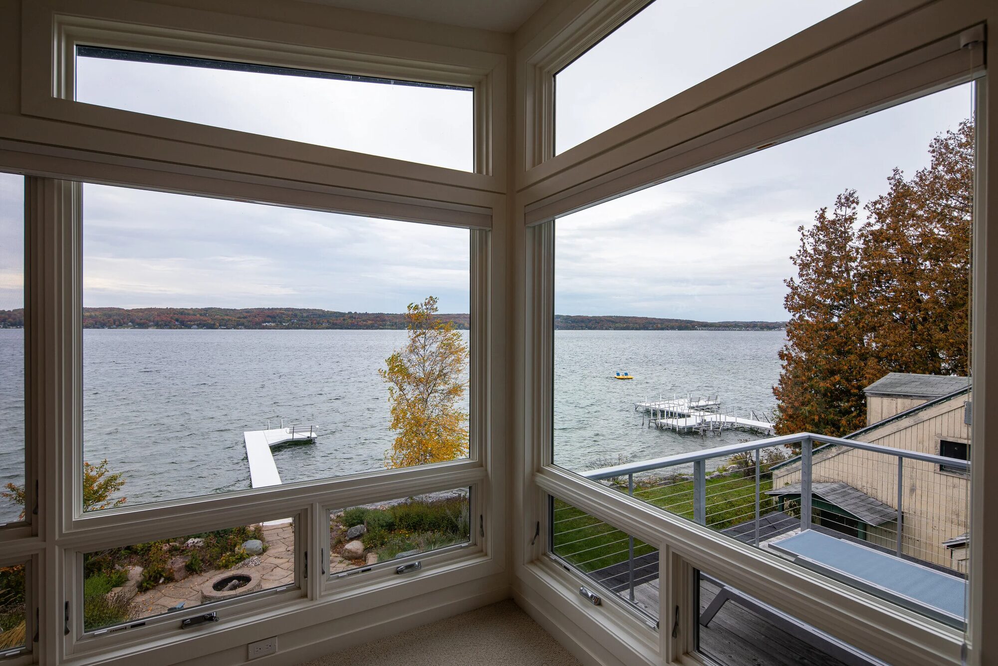 Side elevation of Charlevoix lakefront home with expansive glass framing lake views